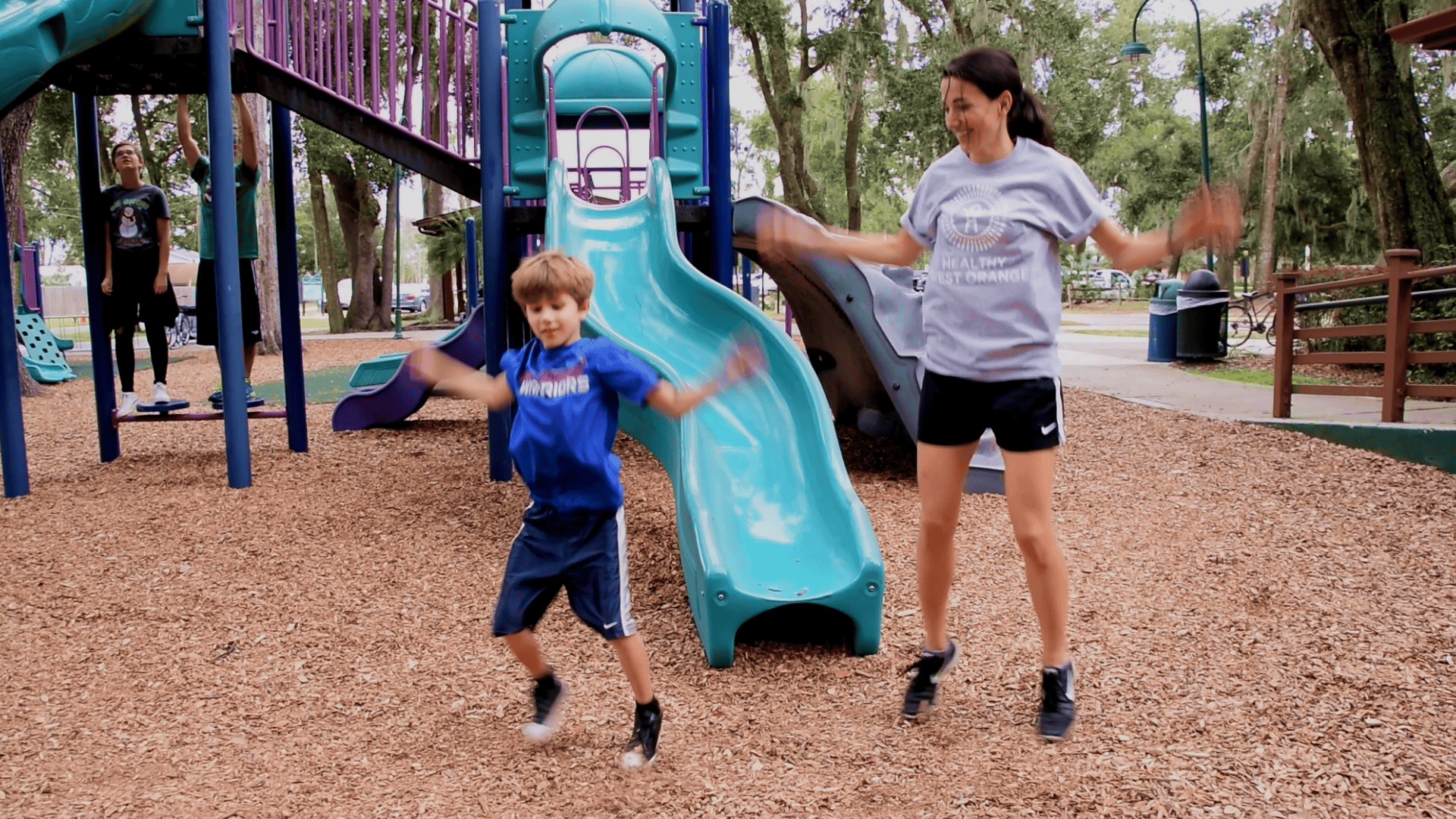 boy and female doing jumping jacks