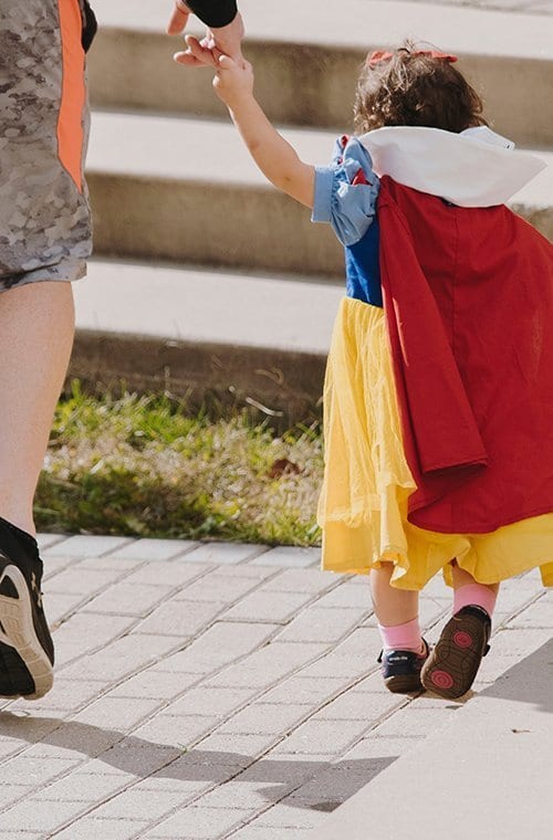 child and mother walking away form camera