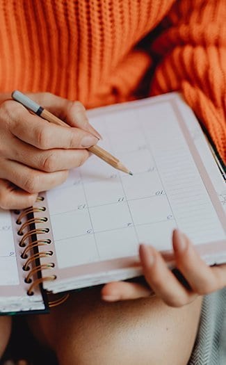 woman writing in planner