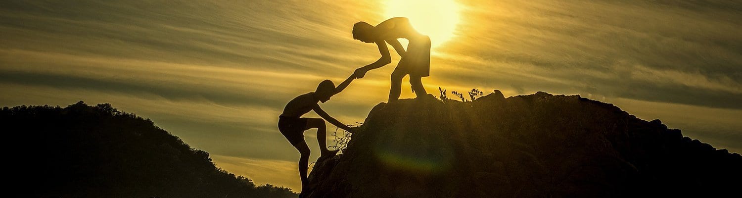 Climbers helping each other