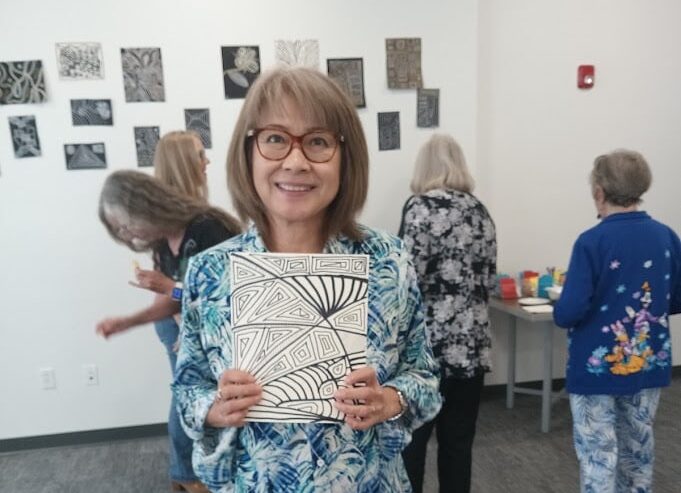Woman holding fine arts project